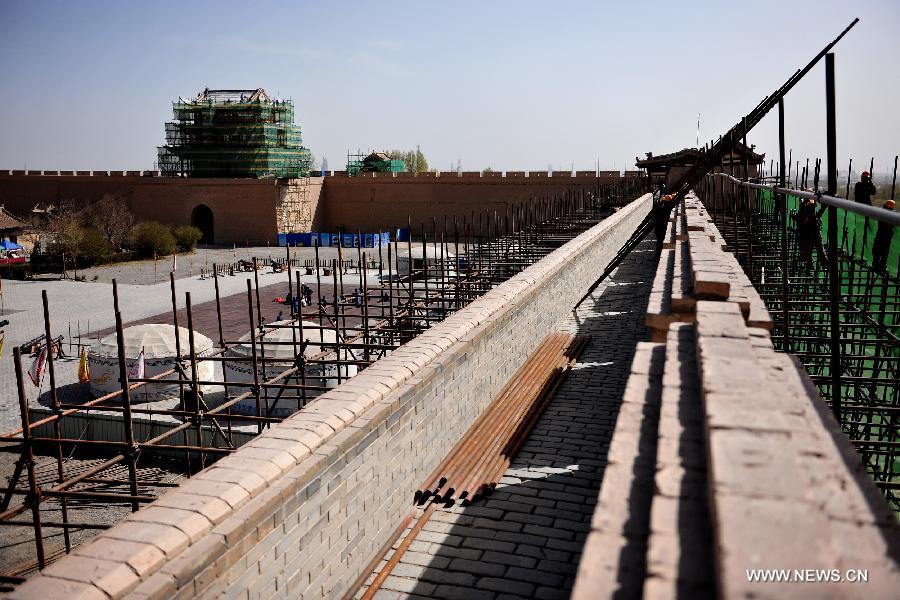 Workers maintain the Jiayu Pass, the starting point of a section of the Great Wall constructed during the Ming Dynasty (1368-1644), in Jiayuguan City, northwest China's Gansu Province, April 16, 2013. China will pour 2.03 billion yuan (about 328 million US dollars) in maintaining the Jiayu Pass, also including the construction of a world culture heritage inspection center and a heritage protection and display project. Built in 1372, the Jiayu Pass also served as a vital passage on the ancient Silk Road. It was listed on UNESCO's World Heritage List in 1987. (Xinhua/Lian Zhenxiang) 