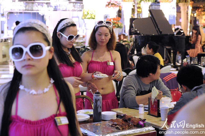 Waitresses wear bikini for promotion at a restaurant in Changsha, Hunan province on April 15, 2013.  (Photo/People's Daily Online)