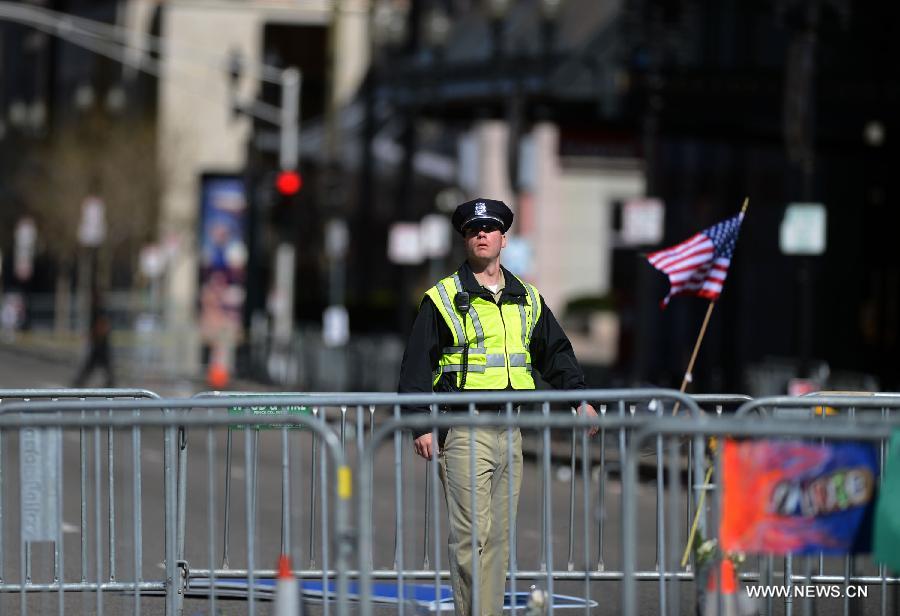 A policeman works at the blast site in Boston, the United States, April 17, 2013. U.S. investigators believed that they have identified a suspect for Monday's Boston Marathon bombings, which killed three people and injured over 170 others, U.S. media reported on Wednesday. (Xinhua/Wang Lei)