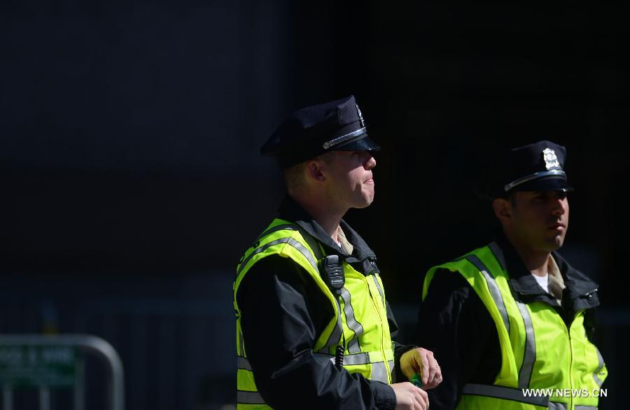 Policemen work at the blast site in Boston, the United States, April 17, 2013. U.S. investigators believed that they have identified a suspect for Monday's Boston Marathon bombings, which killed three people and injured over 170 others, U.S. media reported on Wednesday. (Xinhua/Wang Lei)  