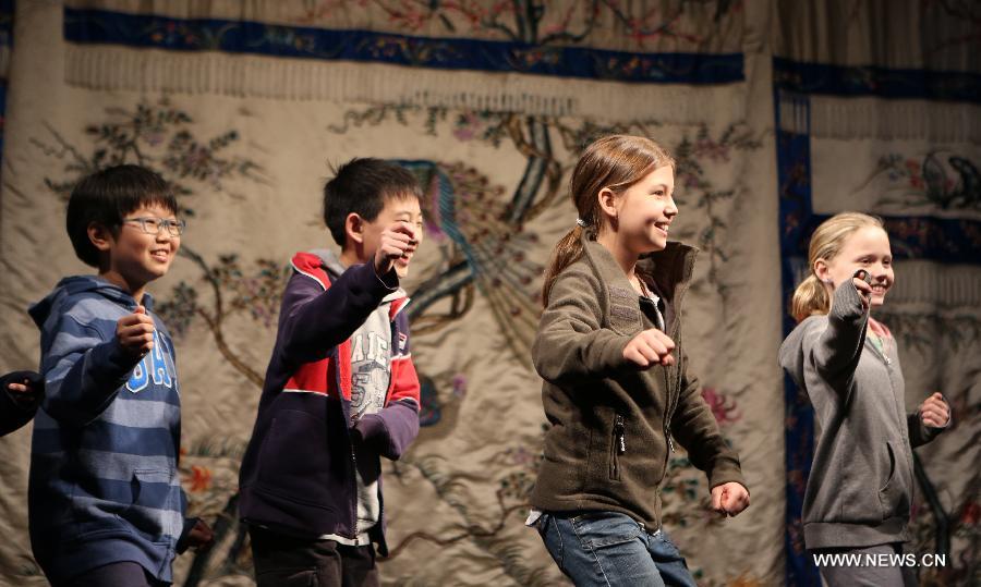 Children learn Peking Opera performance at the Temple Theatre Beijing Opera House in Beijing, capital of China, April 18, 2013. Students from an international school in Beijing participated in a public education activity named "the charm of Sheng, Dan, Jing, Chou in Peking Opera" on Thursday here. "Sheng","Dan","Jing" and "Chou" refer to different roles in Peking Opera. (Xinhua/Pan Siwei) 