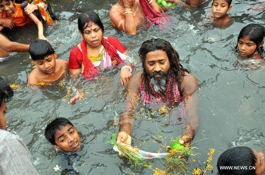 Bangladeshi Hindu devotees take a holy bath and pray in the Brahmputra river during Astami Snan religious festival at Langalbandh, southeast of Dhaka, Bangladesh, on April 18, 2013. Thousands of Hindu devotees Thursday celebrated one of the largest religious festivals of the Hindu community Astami Snan across the country. (Xinhua/Shariful Islam) 