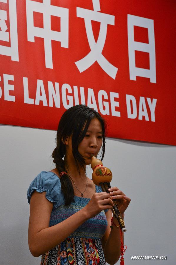 Columbia University student Zhu Ye plays Hulusi or cucurbit flute, a traditional Chinese wind instrument, during an event to celebrate the United Nations Chinese Language Day, at UN Plaza in New York, on April 19, 2013. (Xinhua/Niu Xiaolei)