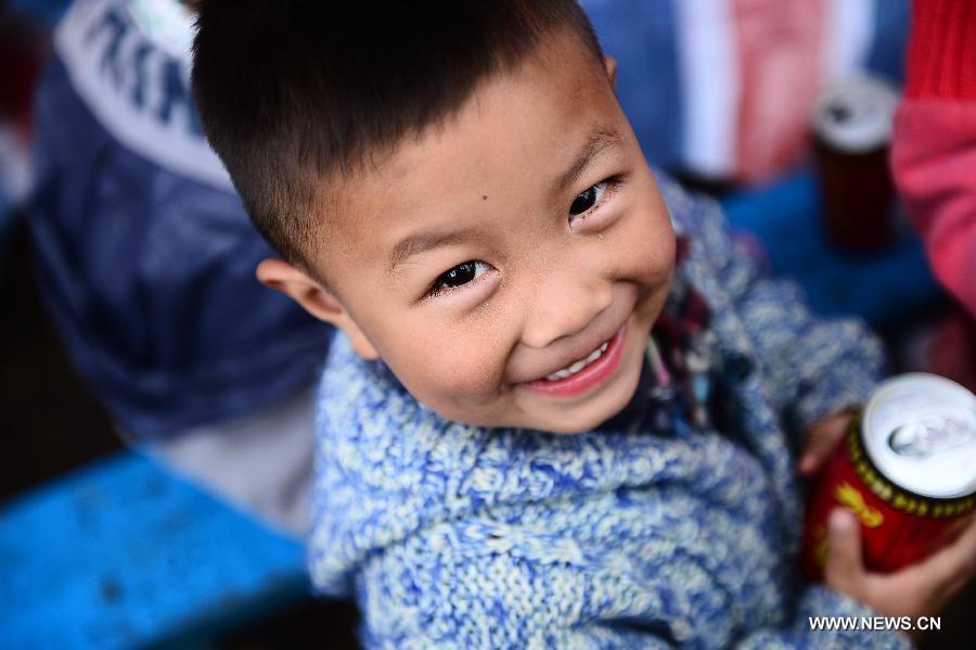 Two-year-old boy Zhu Yule smiles at a temporary settlement site in the quake-hit Lushan County, southwest China's Sichuan Province, April 22, 2013. (Xinhua/Zhang Hongxiang)