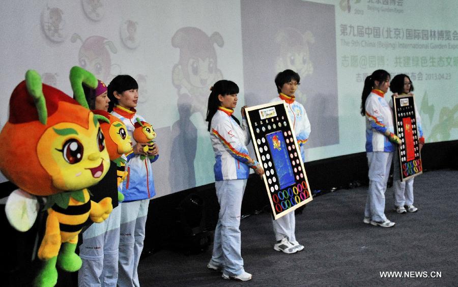 Volunteers present costumes, the mascot and the mascot-related products designed for the volunteers of the ninth China (Beijing) International Garden Expo at a press conference in Beijing, capital of China, April 23, 2013. The mascot for volunteers is given a nickname of "Little V Bee" as V stands for victory and bee is a symbol of diligence in Chinese culture. A total of 51,096 people have so far registered for the volunteer service during the expo. (Xinhua/Li Xin)