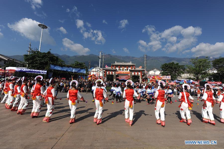 People in traditional costumes dance to celebrate the opening of March Street Festival in Dali Bai Autonomous Prefecture, southwest China's Yunnan Province , April 24, 2013. The 2013 Dali March Street Festival, opening each year on March 15 of Chinese Lunar calendar, is a traditional carnival of Bai ethnic group containing folk art and sports activity and merchandise expo. (Xinhua/Qin Qing)