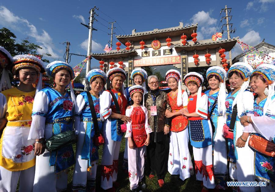 People in traditional costumes pose for a photo to celebrate the opening of March Street Festival in Dali Bai Autonomous Prefecture, southwest China's Yunnan Province , April 24, 2013. The 2013 Dali March Street Festival, opening each year on March 15 of Chinese Lunar calendar, is a traditional carnival of Bai ethnic group containing folk art and sports activity and merchandise expo. (Xinhua/Qin Qing)