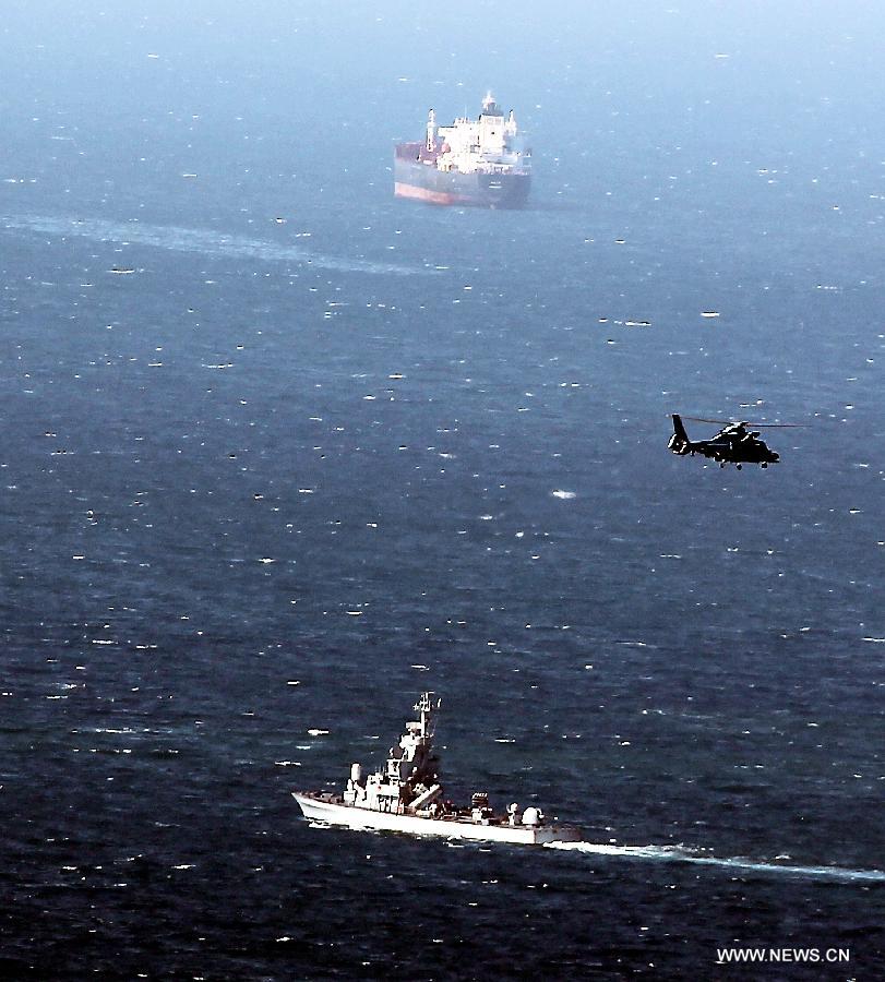 An Israeli military naval ship and an Israeli air force helicopter operate next to a cruise ship off the coast of Haifa, northern Israel, Thursday, April 25, 2013. An Israeli Air Force F-16 fighter jet downed a drone off the coastline of the northern city of Haifa at noon of Thursday, the Israeli Defense Forces (IDF) said. (Xinhua/Jini)