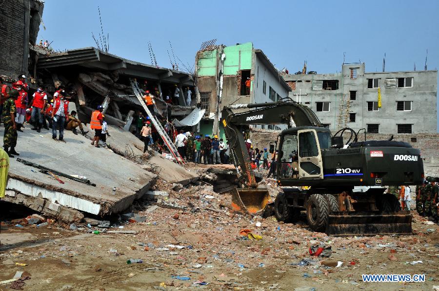 Rescuers work at the collapsed Rana Plaza building in Savar on the outskirts of Dhaka, Bangladesh, April 27, 2013. In the wake of violent protests over Wednesday's building collapse that has left 332 workers dead so far, two of the owners of five ready-made garment factories housed in the collapsed Bangladesh building were arrested early Saturday. (Xinhua/Shariful Islam)