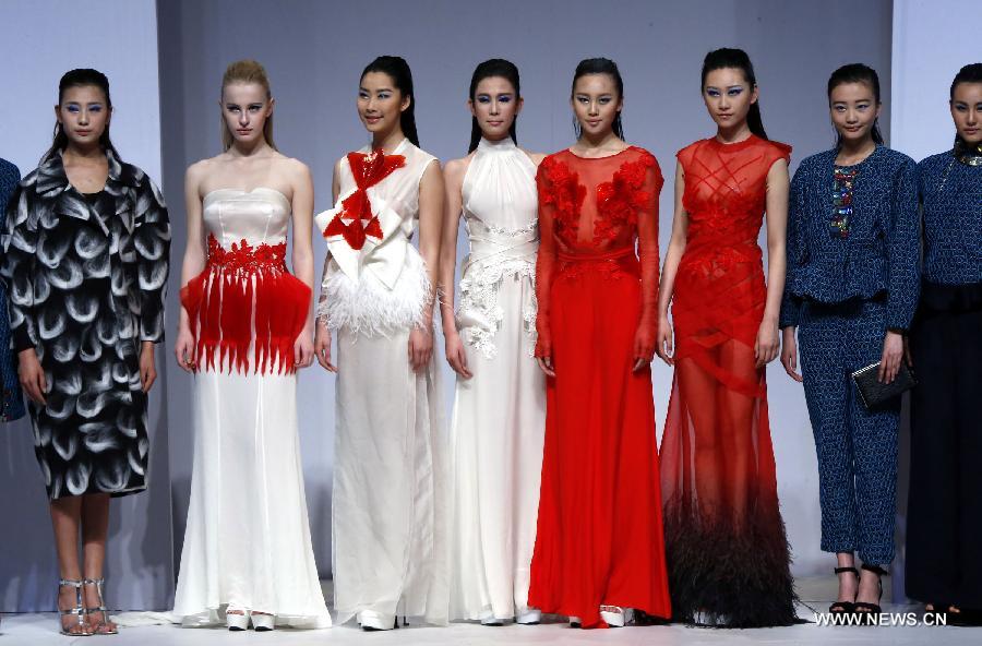 Models present creations designed by graduates from the College of Art and Design of Wuhan Textile University during the China Graduate Fashion Week in Beijing, capital of China, April 27, 2013. (Xinhua/Li Mingfang) 