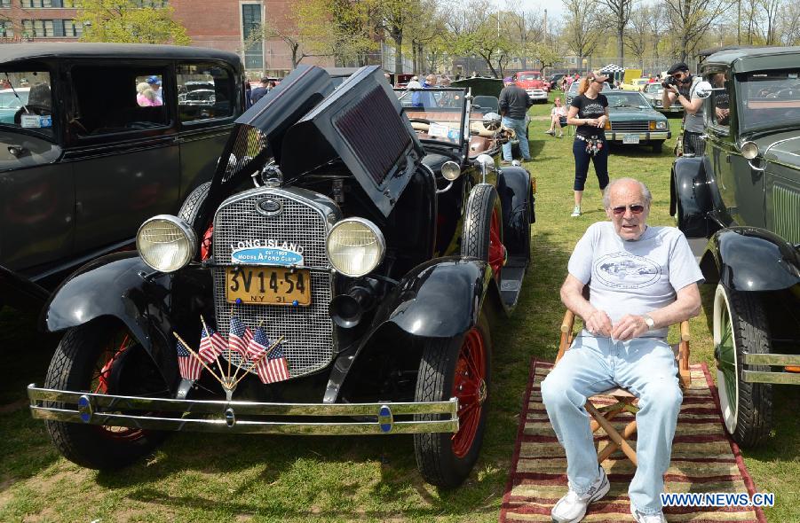 Owner sits next to his vintage Ford car during an antique auto show in New York, the United States, on April 28, 2013. (Xinhua/Wang Lei)