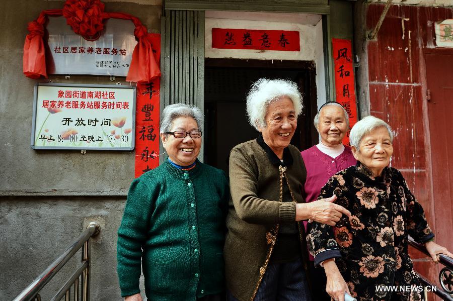 Senior citizens walk out of a community service center in Jin'an District of Fuzhou, capital of southeast China's Fujian Province, April 27, 2013. A total of 435 community service centers have been set up in Fuzhou since 2008 to provide daily care and entertainment activities for senior citizens. (Xinhua/Zhang Guojun)  