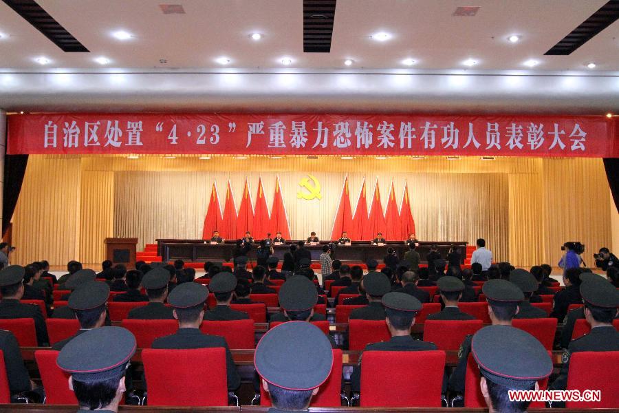 Photo taken on April 29, 2013 shows the scene of a commendation meeting held to award the 15 community workers and police officers who died during a terrorist clash on April 23 in Bachu County, Kashgar Prefecture, northwest China's Xinjiang Uygur Autonomous Region. The regional Communist Party of China (CPC) committee and government posthumously awarded the 15 individuals each as a "regional anti-terrorist hero," seven of whom were also posthumously awarded as a "regional outstanding CPC member". (Xinhua/Zhang Huawei)