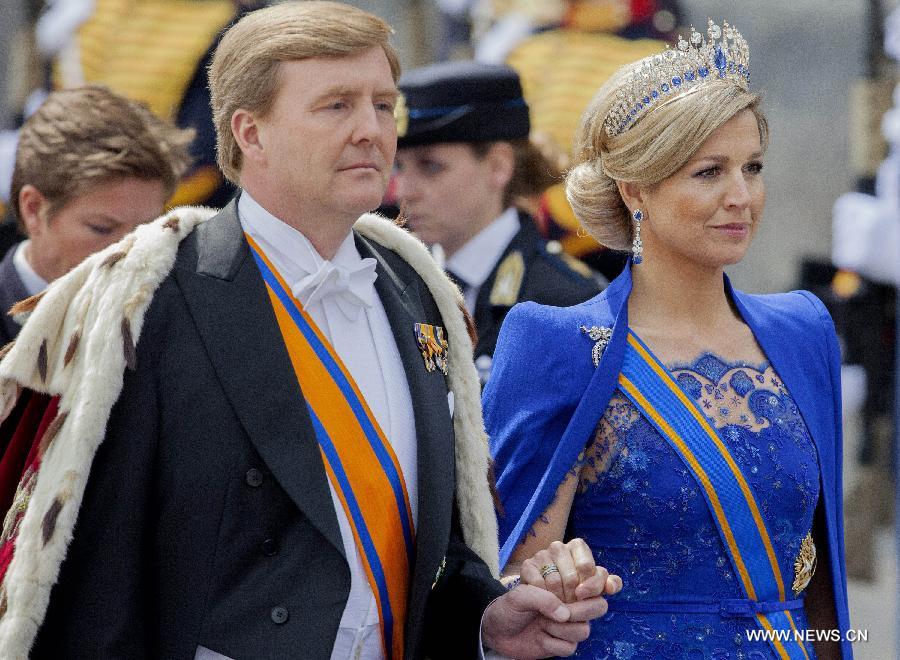 Dutch King Willem-Alexander (L) and his wife Maxima (R) step to the Church in Amsterdam to swear in, on April 30, 2013. Following the abdication of Queen Beatrix, the new King of the Netherlands Willem-Alexander was officially inaugurated on Tuesday. (Xinhua/Rick Nederstigt)