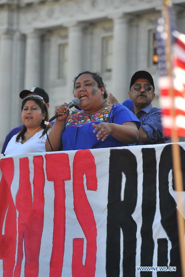 Olga Miranda (C), spokeswoman of a labour union, addresses a rally to urge a reform of immigration policy in San Francisco, California, the United States, on May 1, 2013. People attended the rally held by labour unions and labour rights protection institutions to urge the U.S. congress to legalize the immigration reform as soon as possible on Wednesday. New York, San Francisco, Chicago and Philadelphia held rallies with similar themes on the same day. (Xinhua/Liu Yilin)