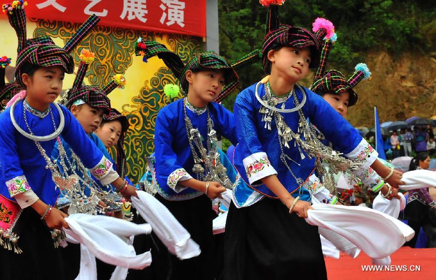 Pupils of Zhuang ethnic group perform during the traditional "Huajie Festival" of Zhuang ethnic group, in Guangnan County, southwest China's Yunnan Province, May 2, 2013. (Xinhua/Chen Haining)