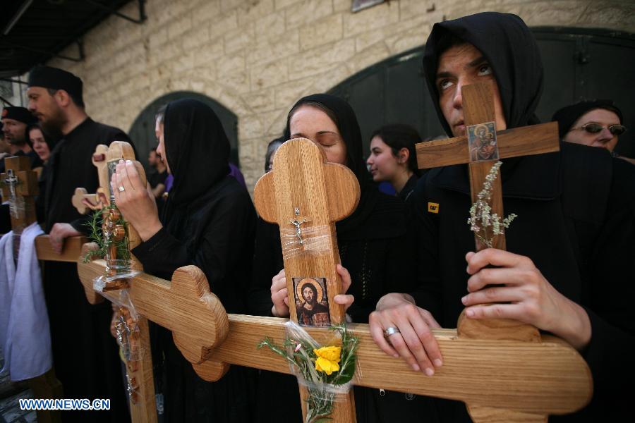 Christian Orthodox pilgrims carry wooden crosses along the Via Dolorosa during a procession marking the Orthodox Good Friday on May 3, 2013 in Jerusalem's old city. (Xinhua/Muammar Awad) 