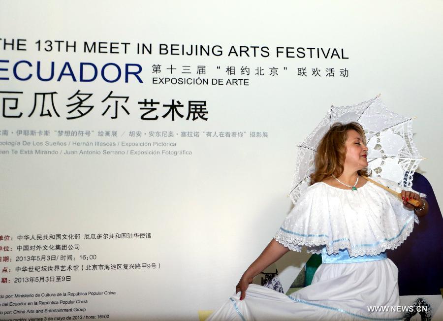 An actress presents Ecuadorian folk costumes at the Ecuador Art Exposition, an event of the 13th Meet in Beijing Arts Festival in Beijing, capital of China, May 3, 2013. A total of 83 works will be displayed at the exposition that kicked off on Friday. (Xinhua/Pan Siwei)