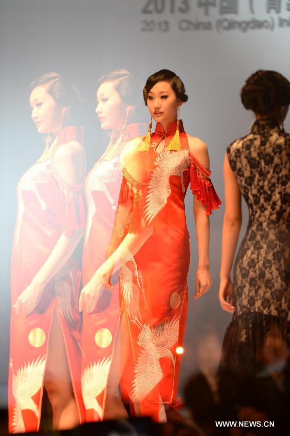 Photo taken on May 5 with multiple exposure camera settings shows a model presenting fashion creation designed by Gao Lixin during the 2013 China (Qingdao) International Fashion Week in Qingdao, a coastal city in east China's Shandong Province, May 5, 2013. (Xinhua/Li Ziheng) 