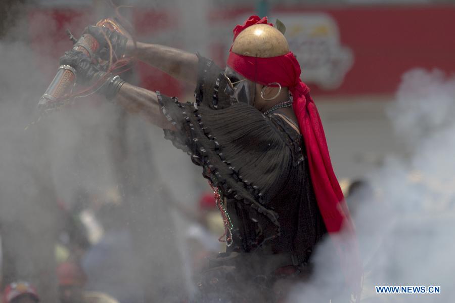 A resident participates in the celebrations of 151st anniversary of the Battle of Puebla, at the Penon de los Banos neighborhood, in Mexico City, capital of Mexico, on May 5, 2013. The Battle of Puebla took place on May 5 1862 near the city of Puebla during the French intervention in Mexico. The Mexican victory is celebrated yearly on May 5. (Xinhua/Alejandro Ayala) 