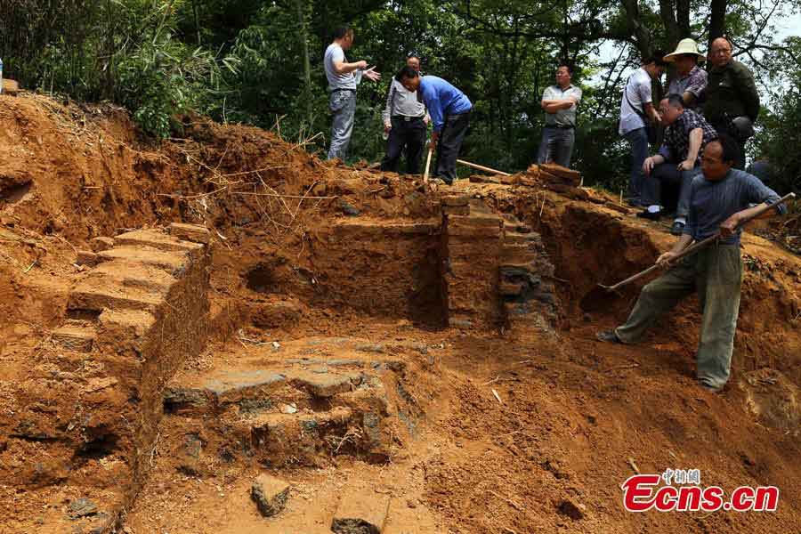 Bricks with patterns are found in an ancient tomb dating back to the Eastern Han Dynasty (25 AD-220 AD) in Gongqingcheng, Jiangxi Province, May 6, 2013. Burial objects including pieces of pottery and ironware were discovered in the tomb.(CNS/Liu Zhijian)