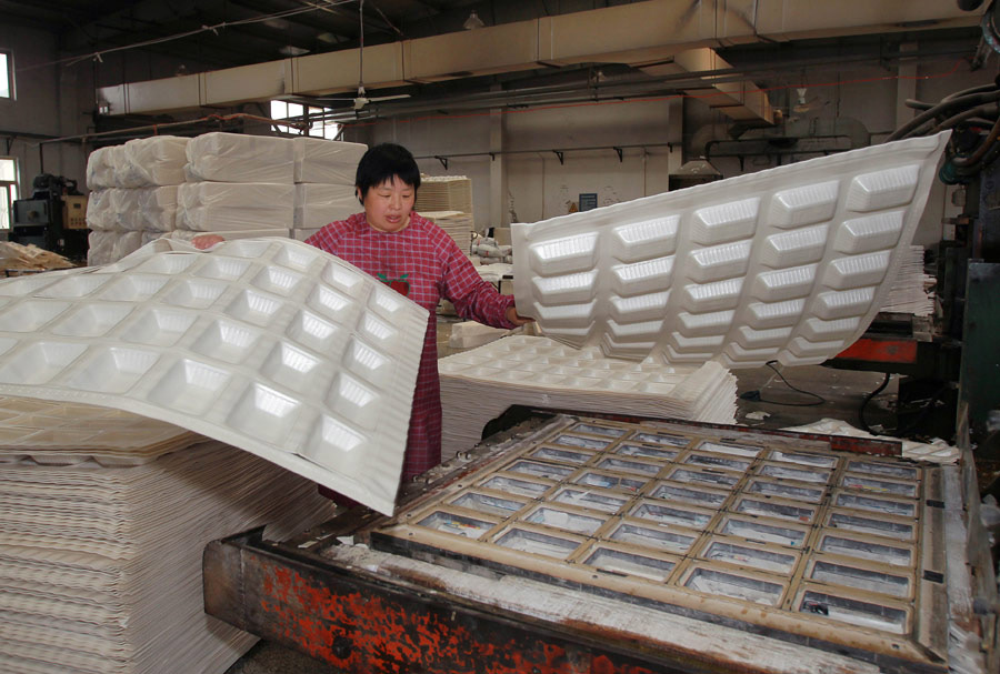 The semi-finished products of disposable foam plastic tableware. (Xinhua/Ding Ting)