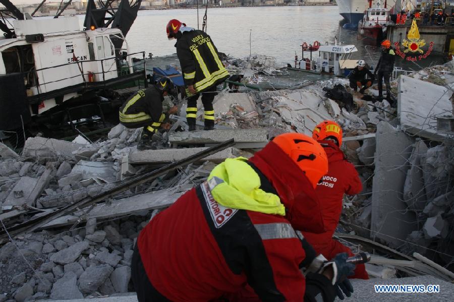 This photo released by Italian Vigili del Fuoco (Italian fire service) shows rescue workers inspecting the debris of the collapsed control tower at north Italy's Genoa port on May 8, 2013. The death toll of the Italian ship's accident in the northern Genoa port rose to seven late on Wednesday while more were injured or missing. Divers were still searching bodies trapped in the underwater rubble of a 50-meter-tall control tower that was demolished by the container ship Jolly Nero on Tuesday night. The ship, 239 meters long and with a gross tonnage of nearly 40,600 tonnes, suddenly crashed into the concrete and glass tower while maneuvering out the port in calm conditions. (Xinhua/Italian Vigili del Fuoco)