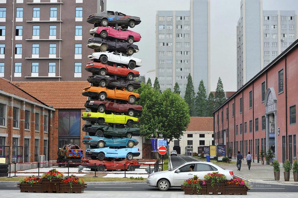 13 discarded vehicles of different colors are used in creating a 10-meter-high art work named "Regeneration 2013" at Wuhan Culture Creation Industrial Park in Hubei province.(Photo/Xinhua)