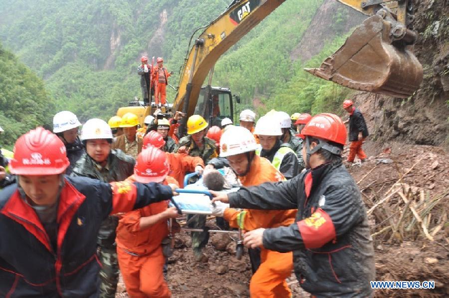 Rescuers transfer an injured person at the accident site after a landslide occurred in Lushan County of Ya'an City, southwest China's Sichuan Province, May 9, 2013. Two people were killed and another seven injured in the landslide on Thursday morning, when rocks caused by the landslide buried three vehicles with nine people aboard. The accident took place at the epicenter of a 7.0-Magnitude earthquake that struck on April 20. (Xinhua) 