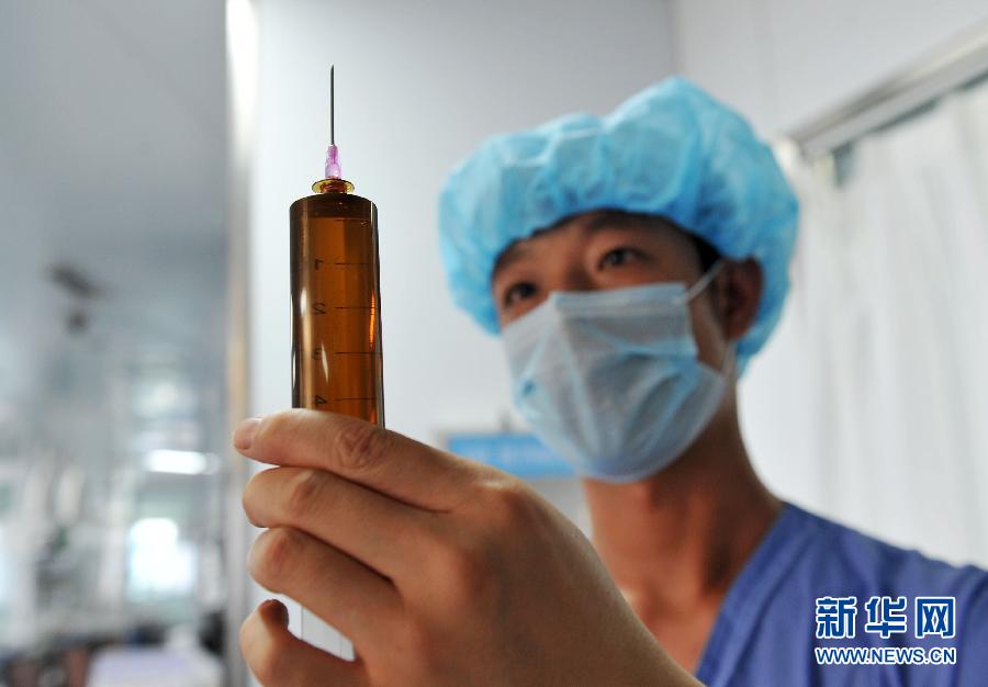 Zeng Lei, 24, expels air from a syringe in the ICU at the affiliated hospital of Ningxia Medical University in the Ningxia Hui autonomous region, April 8. Zeng became a nurse after graduating from university in 2011. He had to overcome the embarrassment of choosing to be a male nurse, and now he is much more comfortable with taking care of patients. He takes five shifts at the ICU every week, and is not a stranger to overtime work. (Photo/Xinhua)