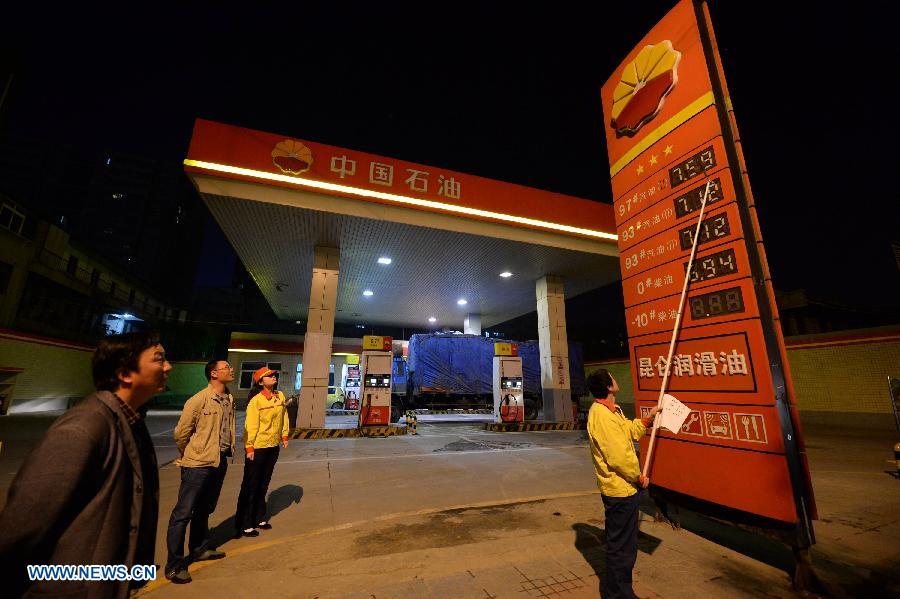 A gas station staff member changes the fuel price tags in Xi'an, capital of northwest China's Shaanxi Province, at the midnight on May 10, 2013. China slightly hiked gasoline and diesel prices starting May 10, the first increase since the fuel pricing scheme was reformed in March. The retail price of both gasoline and diesel was raised by 95 yuan (15.32 U.S. dollars) per tonne, the National Development and Reform Commission (NDRC), the country's top economic planner, said on May 9. The benchmark retail price of gasoline was increased by 0.07 yuan per liter and diesel by 0.08 yuan per liter. (Xinhua/Li Yibo)
