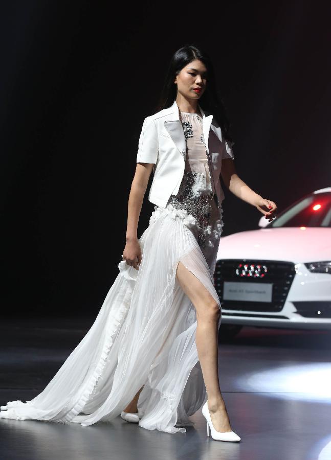 Model Lu Yan presents a creation designed by Masha Ma, a winner of the 2nd Audi Arts and Design Award, during the awarding ceremony of the 2nd Audi Arts and Design Award in Beijing, capital of China, May 9, 2013. Founded in 2010, the Audi Arts and Design Award is a cross-discipline award that focuses on Chinese contemporary arts and design. (Xinhua/Meng Yongmin) 