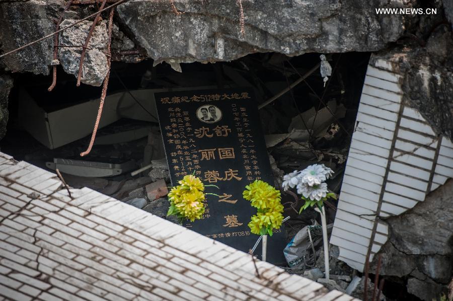 Flowers are placed for a deceased couple in the Wenchuan Earthquake in Beichuan County, southwest China's Sichuan Province, May 11, 2013. Many people returned to the Beichuan county to mourn for the dead as Sunday marks the fifth anniversary of the 8-magnitude quake that rocked Sichuan Province in 2008. (Xinhua/Jiang Hongjing) 