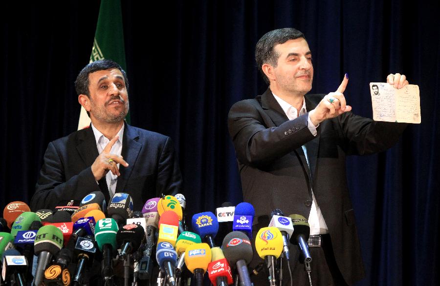 Top aide of President Mahmoud Ahmadinejad, Esfandiar Rahim-Mashaei (R), shows his inked finger during a press conference after he registered for Iran's 11th presidential election at the Interior Ministry in Tehran on May 11, 2013. (Xinhua/Ahmad Halabisaz) 