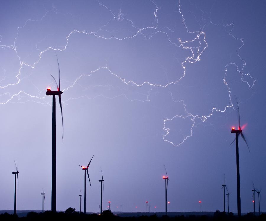 Lightning of a thunder storm illuminates teh sky on May 9, 2013 over a wind energy park near Jacobsdorf, eastern Germany. (Xinhua/AFP Photo)