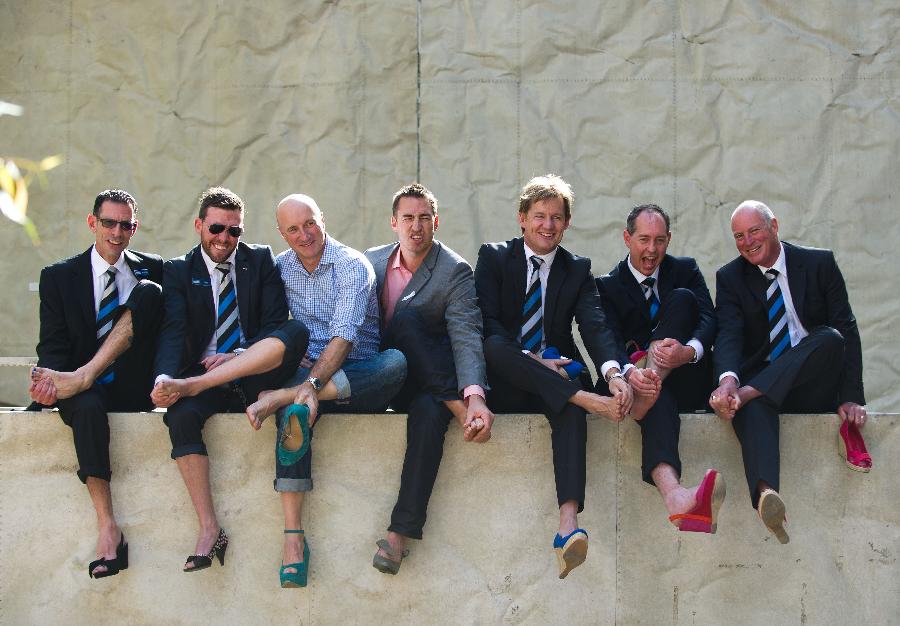 Men wearing high-heel shoes rest after participating in "Walk a Mile in Their Shoes" campaign in the wake of White Ribbon Movement, a campaign led by men to stop violence against women in Melbourne, Australia, May 10, 2013. (Xinhua/Bai Xue) 