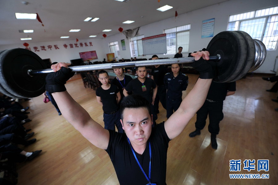 An armed cash transit security guard exercises arm strength. (Xinhua Photo)