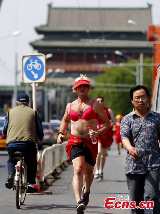 Hundreds of women – and especially men in their red dresses participate in the Red Dress Run in Beijing, May 12, 2013. (CNS/Fu Tian)