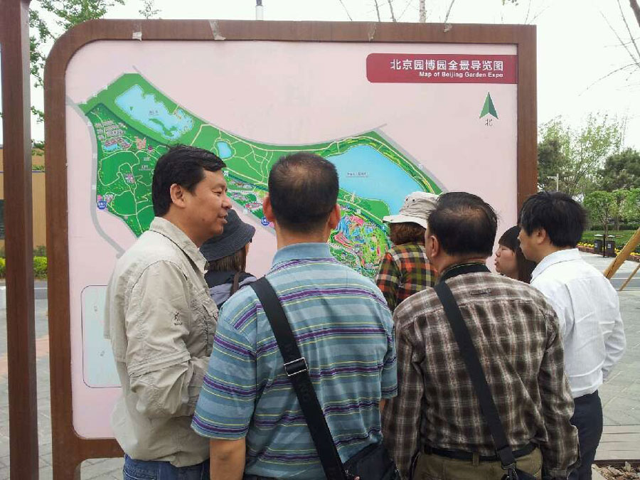 People read a map of the Ninth China (Beijing) International Garden Expo during the expo's trial run on Monday, May 13, 2013. The expo covers an area of 513 hectares, including 267-hecare public exhibition area and 246-hectare Garden Expo Lake. The event will officially kick off on May 18, 2013 and last for six months. (CRIENGLISH.com/Luo Dan)