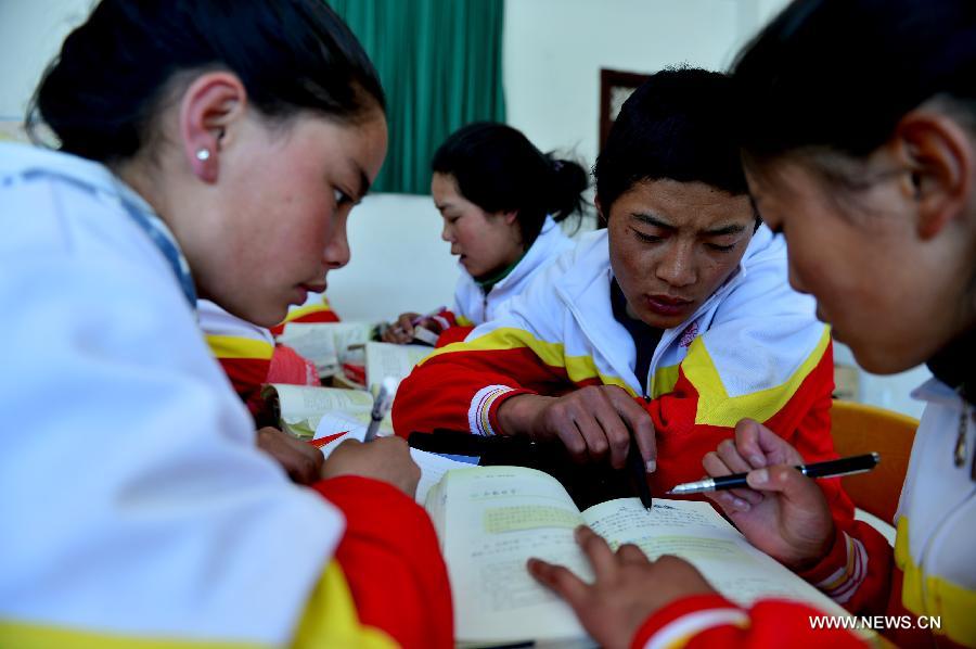 Orphan students of the 7th grade have a team discussion at the Bayi Orphan School in Yushu Tibet Autonomous Prefecture in northwest China's Qinghai Province, May 13, 2013. The school is now a home of 323 orphan students who are instructed and cared by 57 teachers. (Xinhua/Wang Bo)