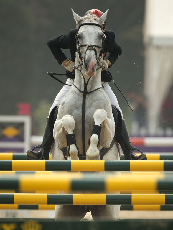 A Chinese rider competes in FEI World Cup Jumping China League, Beijing, May 5, 2013. (Xinhua/Fei Maohua)