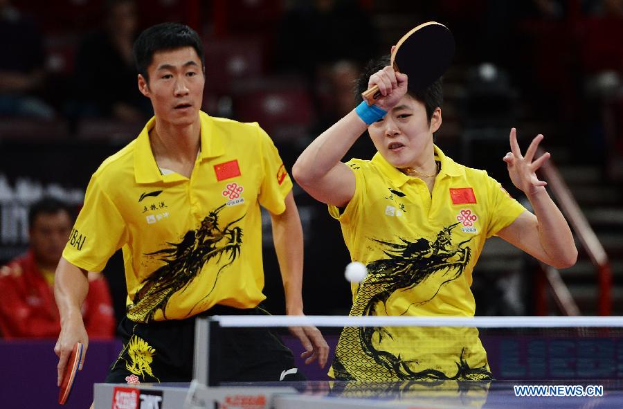Wang Liqin (L) and Rao Jingwen of China compete during the first round of mixed doubles against Thavisack Phathaphone and Thiphakone Southammavong of Laos at Palais omnisport de Paris Bercy in Paris, France, on May 14, 2013. Wang and Rao won 4-0. (Xinhua/Tao Xiyi)