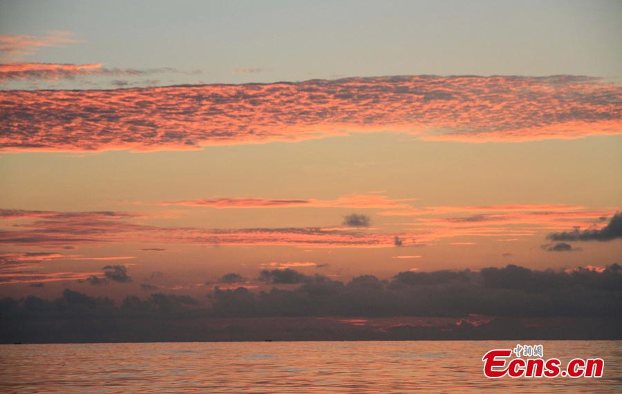 The sky turns red at sunset over waters off the Nansha Islands in the South China Sea, May 14, 2013. A fleet of 32 Chinese fishing boats arrived in Nansha Islands on Tuesday after a 7-day voyage. (CNS/Wang Xiaobin)