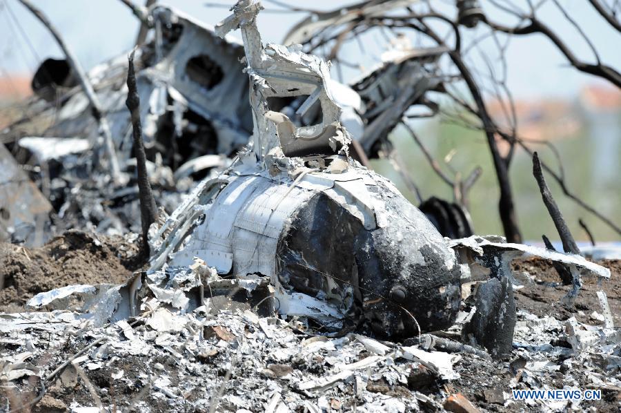Photo taken on May 16, 2013 shows the remains of a light plane after it failed to take off at Taoxian Airport in Shenyang, capital of northeast China's Liaoning Province. Three people on board were injured in the accident on Thursday. (Xinhua/Yang Qing) 