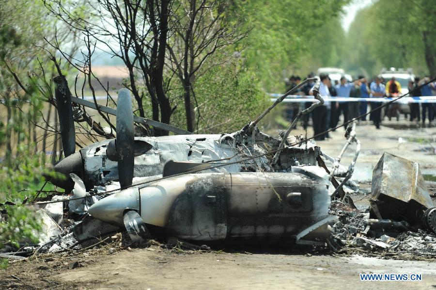 Photo taken on May 16, 2013 shows the remains of a light plane after it failed to take off at Taoxian Airport in Shenyang, capital of northeast China's Liaoning Province. Three people on board were injured in the accident on Thursday. (Xinhua/Pan Yulong) 