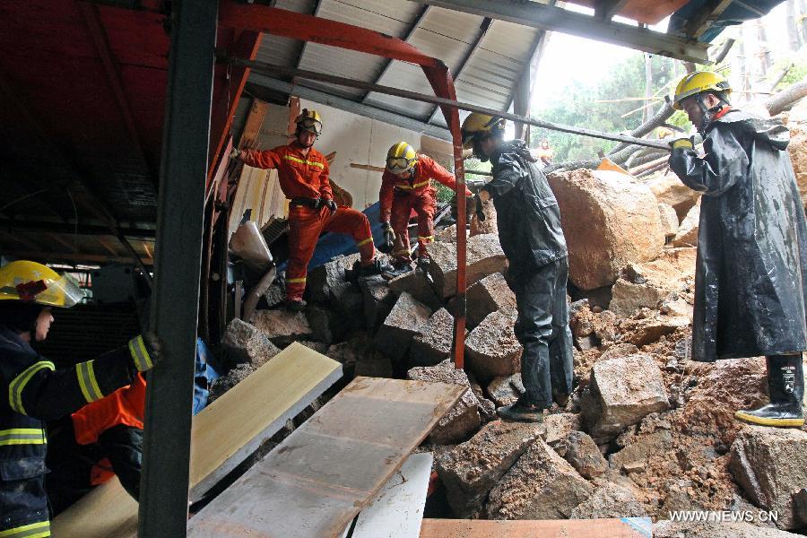 Rescuers work at the site of a landslide in Xiamen, southeast China's Fujian Province, May 16, 2013. Torrential rainfall triggered a landslide at the Qianpu Flea Market in Xiamen early May 16, causing one adult and two children dead. (Xinhua/Zeng Demeng)  