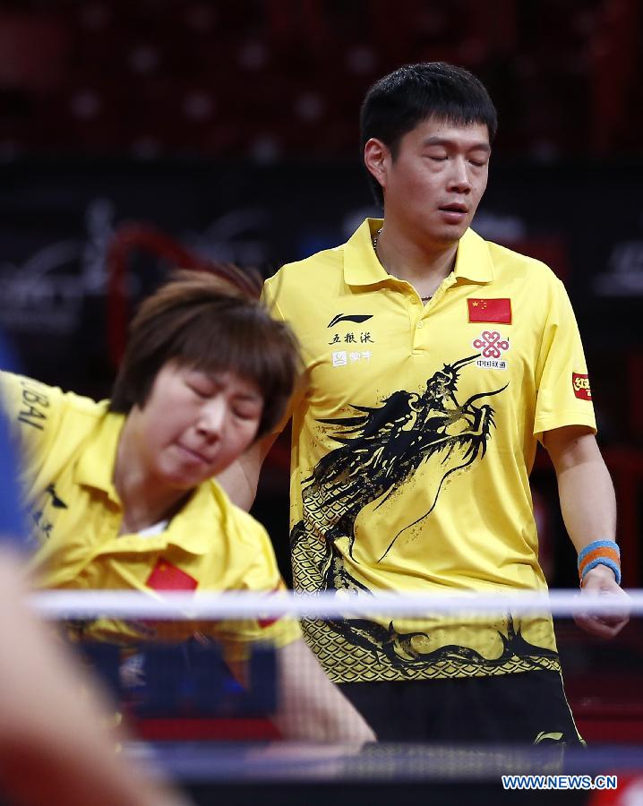 Qiu Yike (R) and Wen Jia of China compete during the round of 16 of mixed doubles against Jiang Tianyi and Lee Ho Ching from Hong Kong of China at the 2013 World Table Tennis Championships in Paris, France on May 16, 2013. Qiu Yike and Wen Jia lost 2-4. (Xinhua/Wang Lili)