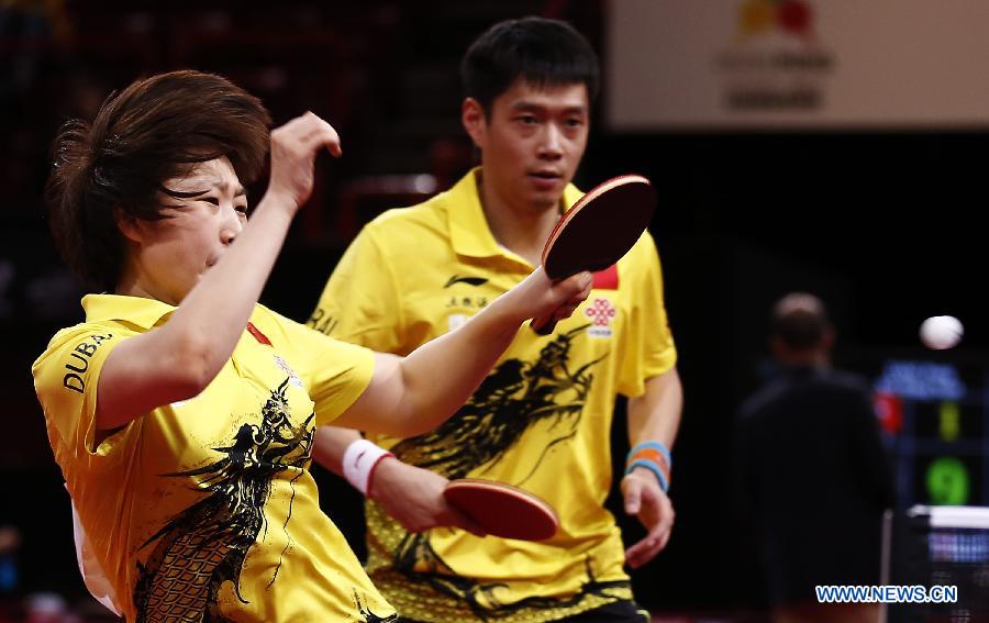 Qiu Yike and Wen Jia (L) of China compete during the round of 16 of mixed doubles against Jiang Tianyi and Lee Ho Ching from Hong Kong of China at the 2013 World Table Tennis Championships in Paris, France on May 16, 2013. Qiu Yike and Wen Jia lost 2-4. (Xinhua/Wang Lili)