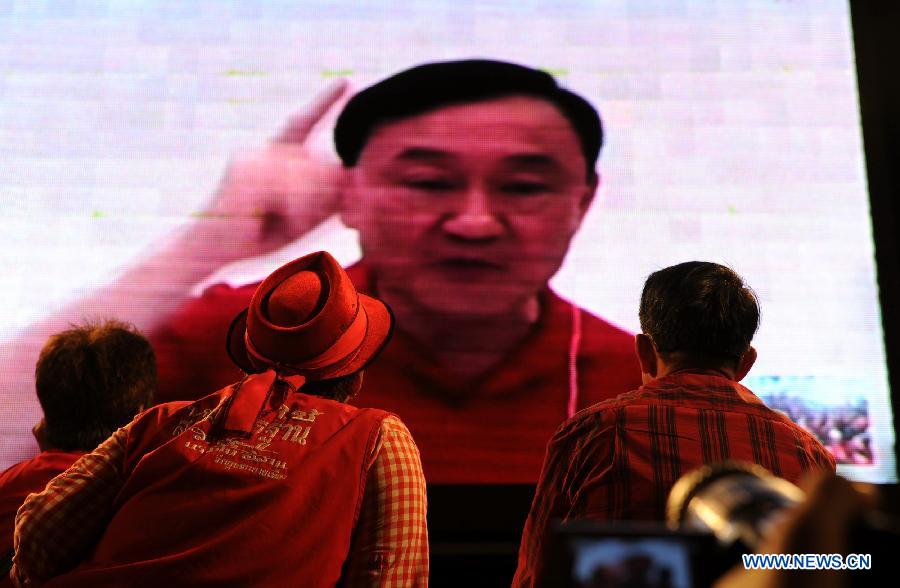Thailand former prime minister Thaksin Shinawatra speaks to his supporters in screen via "Skype" during a rally in the central business district of Bangkok, Thailand, on May 19, 2013. At least 20,000 supporters of the United Front for Democracy against the Dictatorship (UDD), or the Red shirts, gathered in Bangkok on Sunday to commemorate the third anniversary of the military crackdown on the anti-government protesters. (Xinhua/Gao Jianjun) 