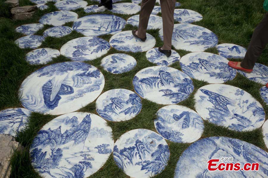 An alley decorated with blue and white porcelain patterns is seen at the Garden Expo Park in Fengtai District, Beijing, May 19, 2013. The Ninth China (Beijing) International Garden Expo kicked off on Saturday. Garden designs from 69 Chinese cities and 29 countries will be presented. (CNS/Liu Guanguan)